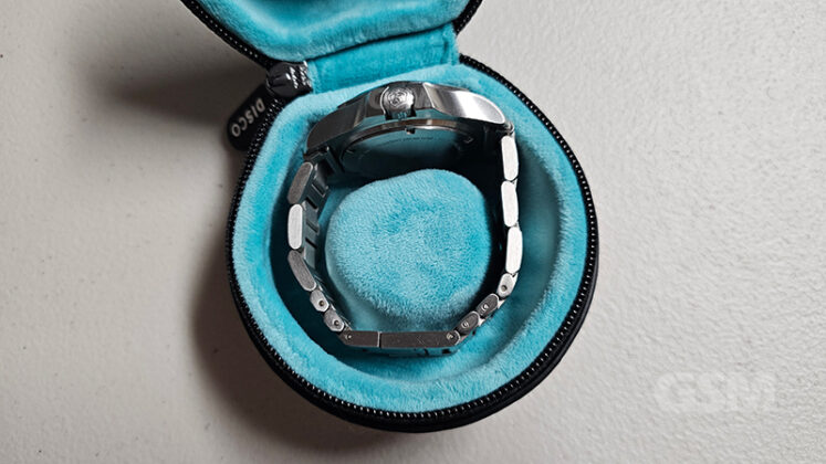Luxury silver wristwatch in a blue velvet case, showcasing high-end men's accessories.