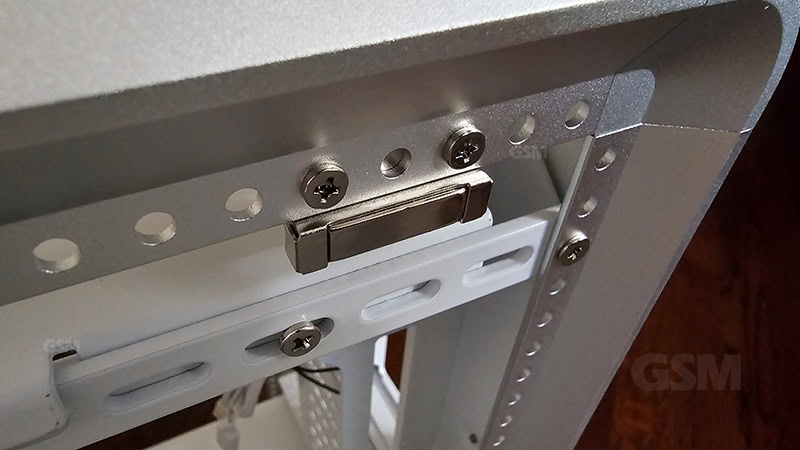Adjustable monitor or TV mounting bracket with metal fasteners and slot for secure installation.